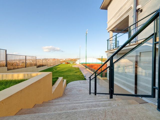 Escalera exterior de hormigón impreso con huellas antideslizantes y molde piedra en el acceso de un chalet