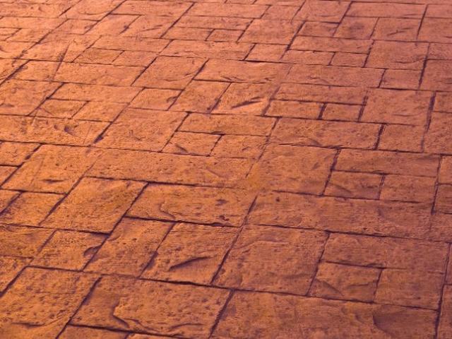 Hormigón impreso molde ladrillo en tono rojo manchego sobre solera existente — Consuegra, Toledo
